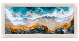 Turquoise surf meets rugged shores.